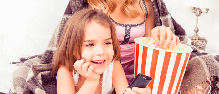 Filha assistindo filme ao lado de sua mãe - Dia das Mães